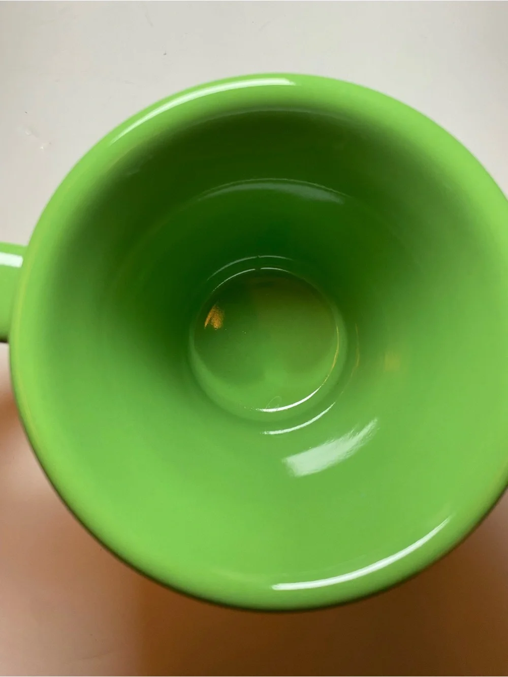 Urth Cafe ceramic coffee mug in green with white embossed logo